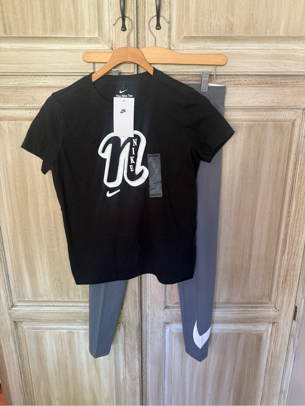 Nike Kids' Black Graphic Logo T-Shirt and grey leggings